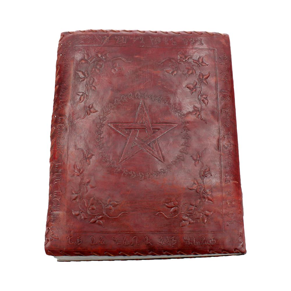 A closed, reddish-brown book displays a pentagram within a leafy circle on its cover. The cover also has floral designs in each corner and unintelligible text along the lower edge.