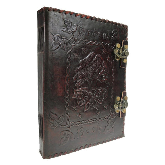 A dark leather-bound book embossed with detailed designs, featuring a raven and foliage, secured by two metal clasps. The words "Dream Book" are engraved on the cover.