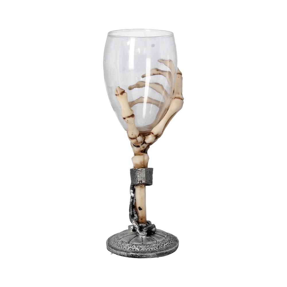 A wine glass is held by a bony hand which reaches from its stem to grasp its base. It’s set against a white background.