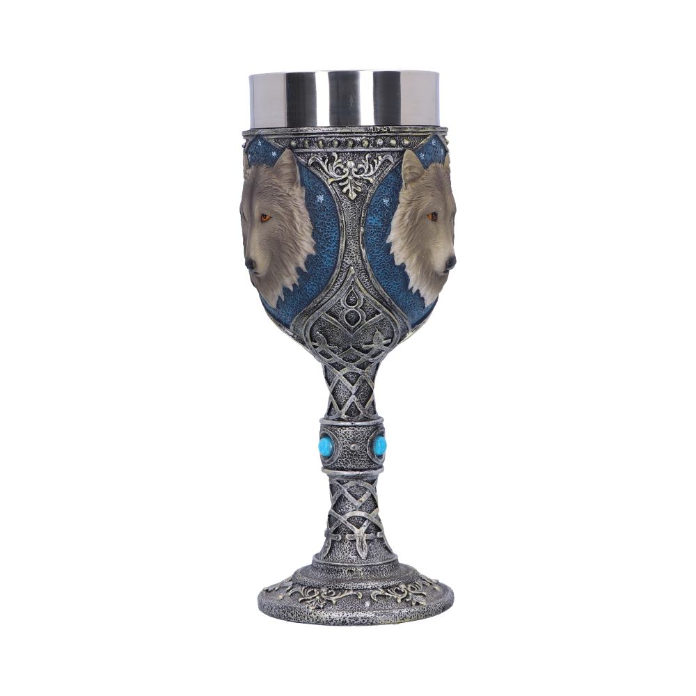 An ornate goblet, in front of a white backdrop, has a steel cup. The stem has turquoise accents and the chalice features wolf heads on a blue background with silver detailing.