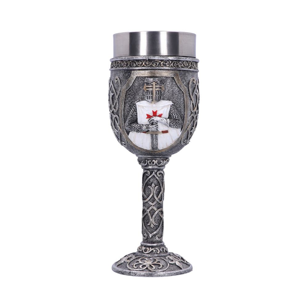 A silver goblet displays a Crusader figure holding a sword on its cup. The goblet has a detailed base and stem on a white background.