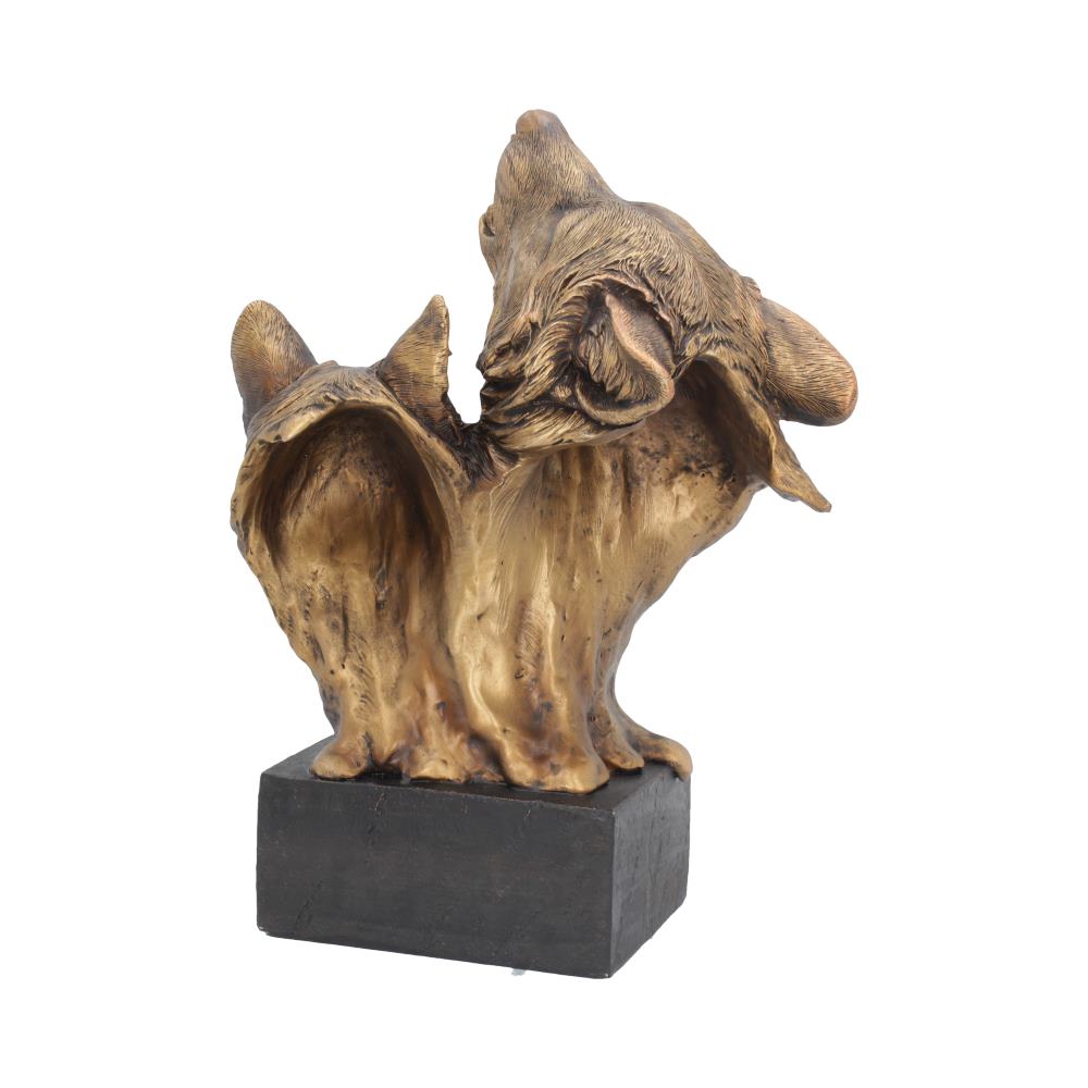 A bronze-finished sculpture of two cats sits on a black rectangular base, with one cat playfully looking back. The sculpture has a textured, abstract design in minimalist surroundings.