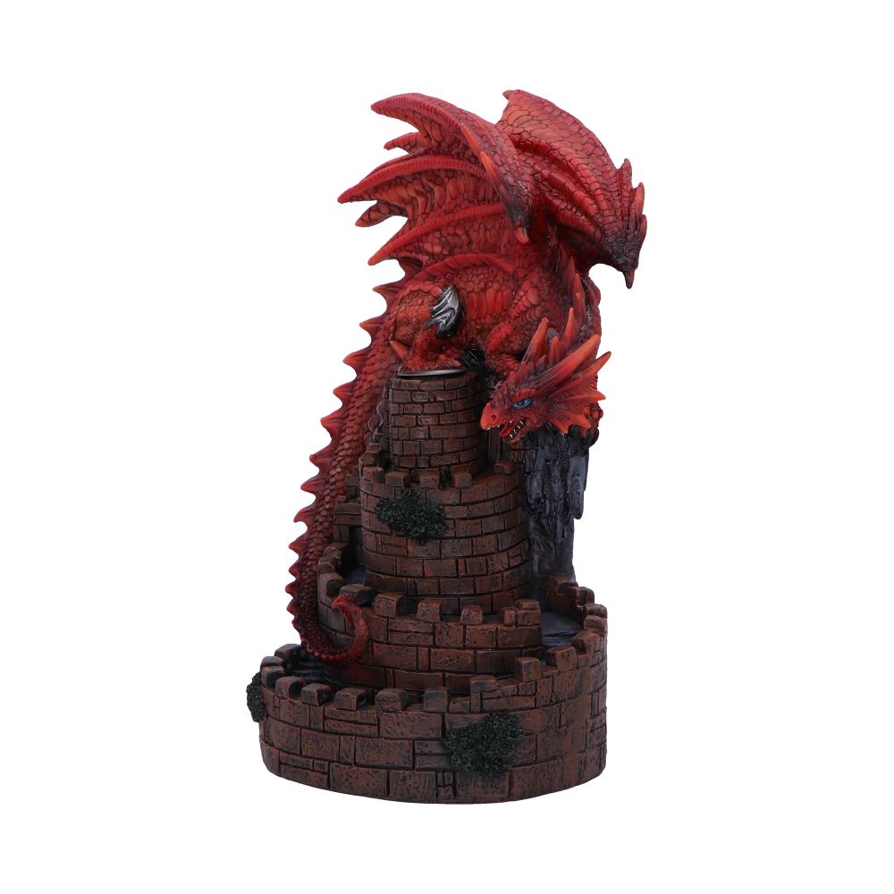A red dragon figurine perches atop a miniature brick tower; its body coils around the structure.  The scene is set against a white background.