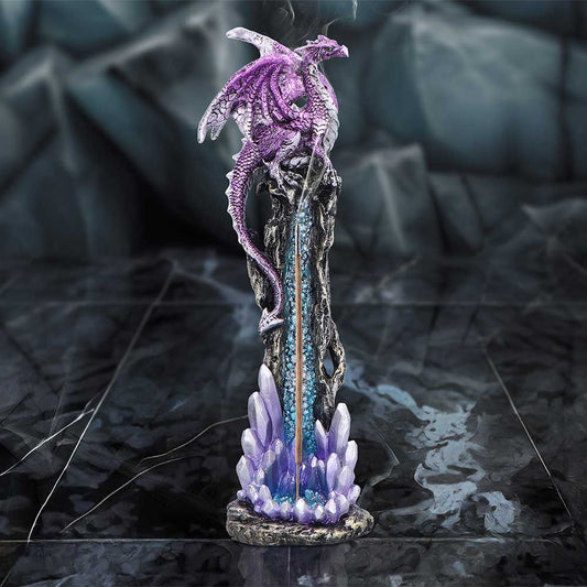 Purple dragon sculpture perches atop a black spire as backflow smoke cascades down into glowing blue purple crystals at its base on a reflective dark tiled floor.
