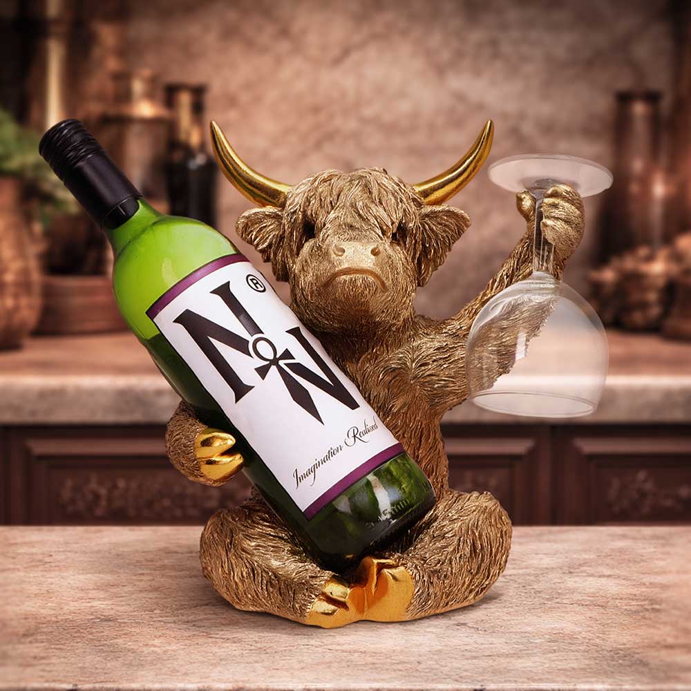 Gold Highland Cow Wine Bottle Holder - cow holder shown with a wine bottle and glass for illustration