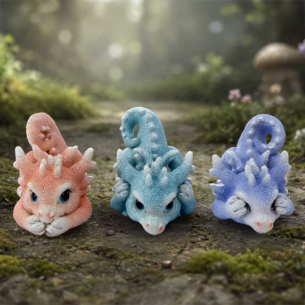 Three Wise Coralscale Dragonlings - pastel Coralscale dragonlings arranged on a woodland-style surface