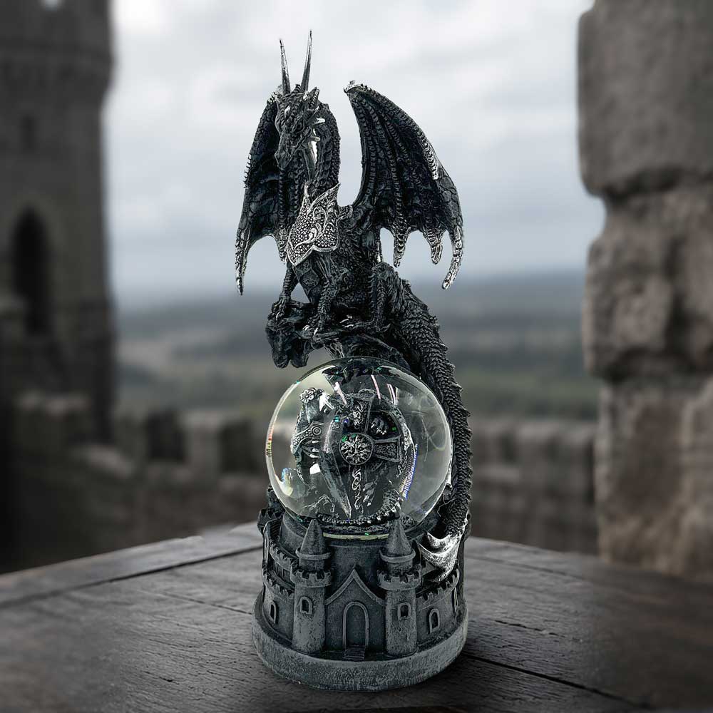 Dragon’s Dominion Snow Globe - dragon snow globe displayed against dark brickwork